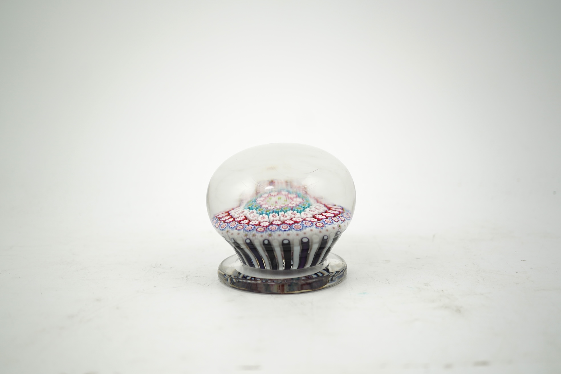 A Clichy piedouche concentric millefiori paperweight, mid 19th century